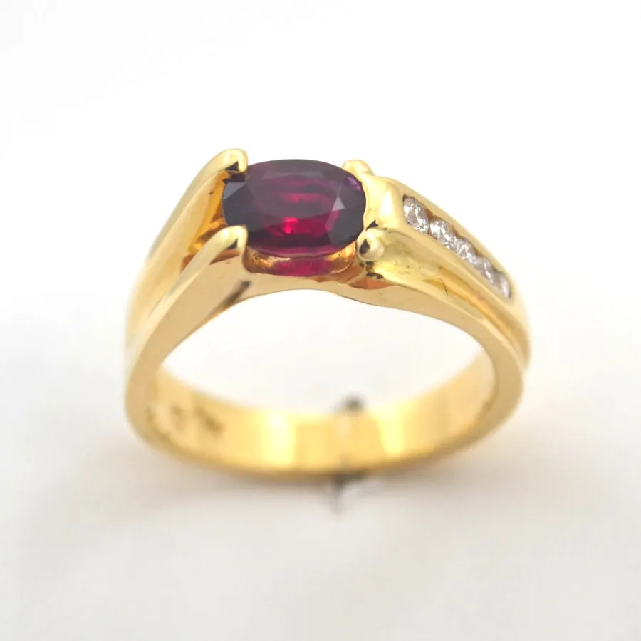 Ruby 484 14K Oval Faceted Ruby (mounted Horizontally) in an artful expression of firey comet. (The 5 channel set Diamonds are earth mined) by Sharon Teaman